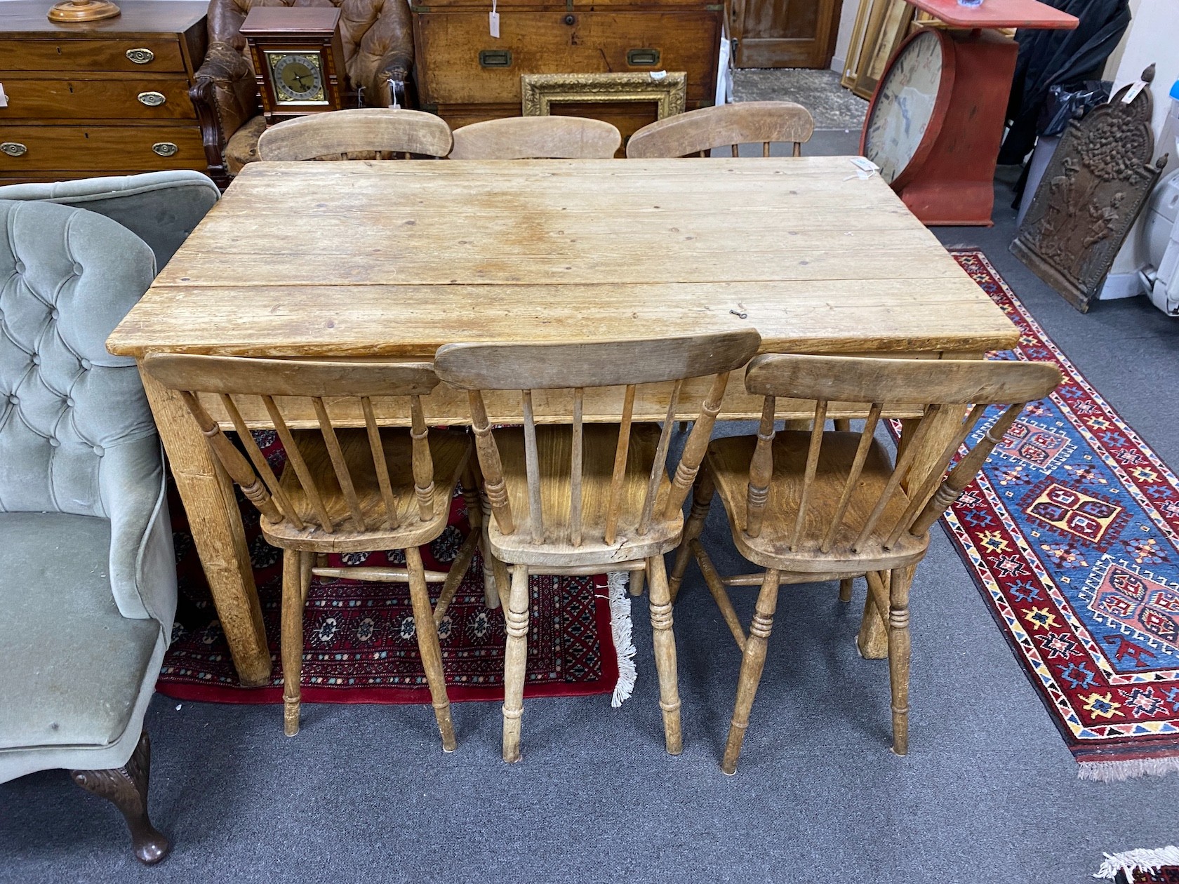 A Victorian rectangular pine kitchen table, length 136cm, depth 81cm, height 77cm together with six Victorian elm and beech Windsor comb back kitchen chairs
